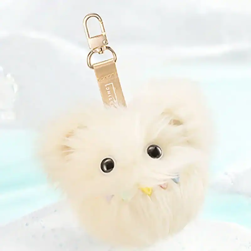 Pomeranian dog plush keychain with black eyes and colorful bow, soft furry accessory for fans of K-pop demon hunters merch.
